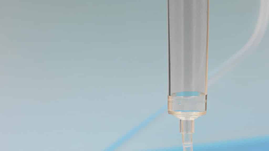 Close-up of an IV drip chamber with clear fluid — professional IV hydration services near Alpharetta and Forsyth County GA