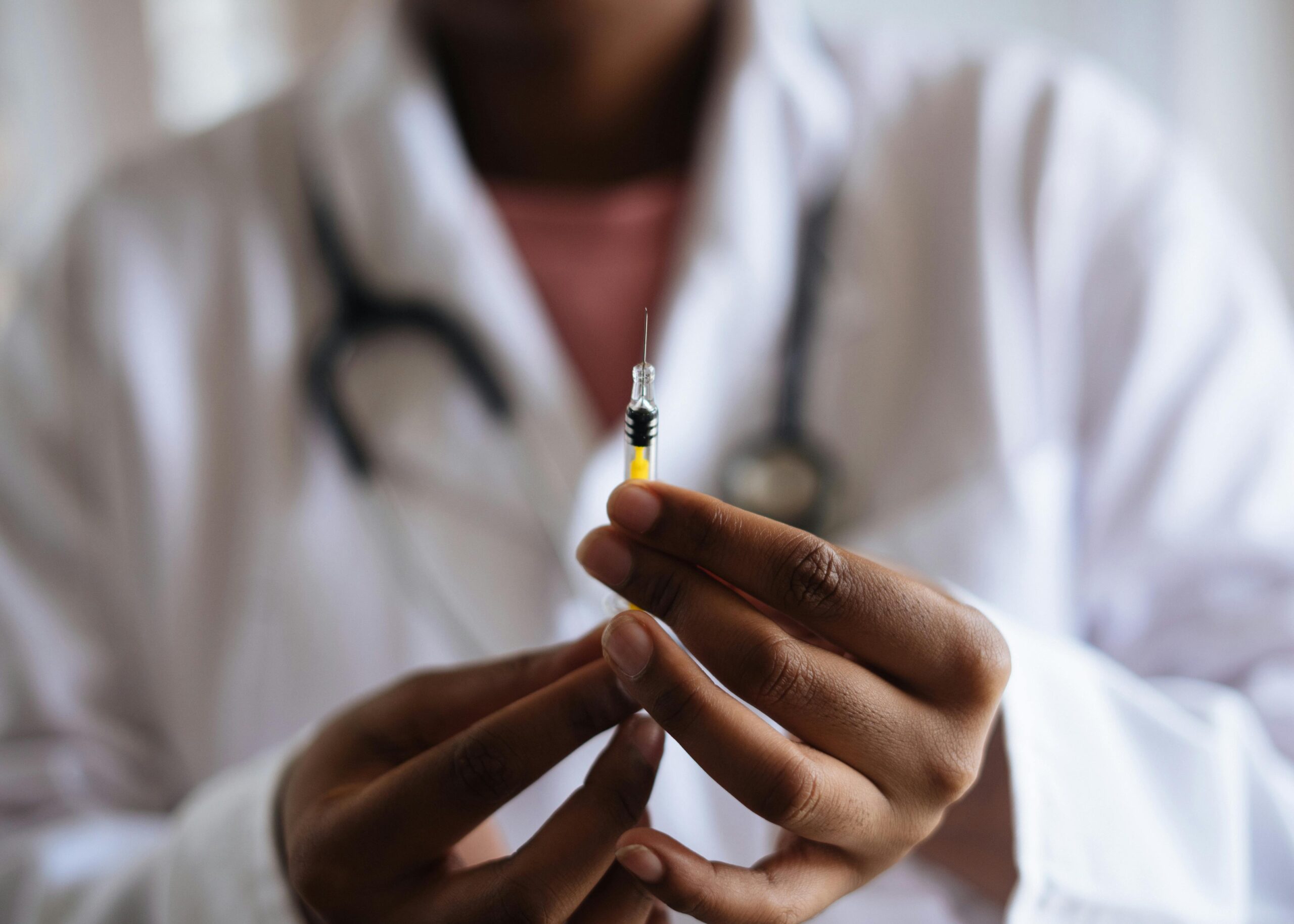 Medical professional holding a syringe filled with B12 injection, used for boosting energy, mood, and wellness at Good Chemistry Med Spa.