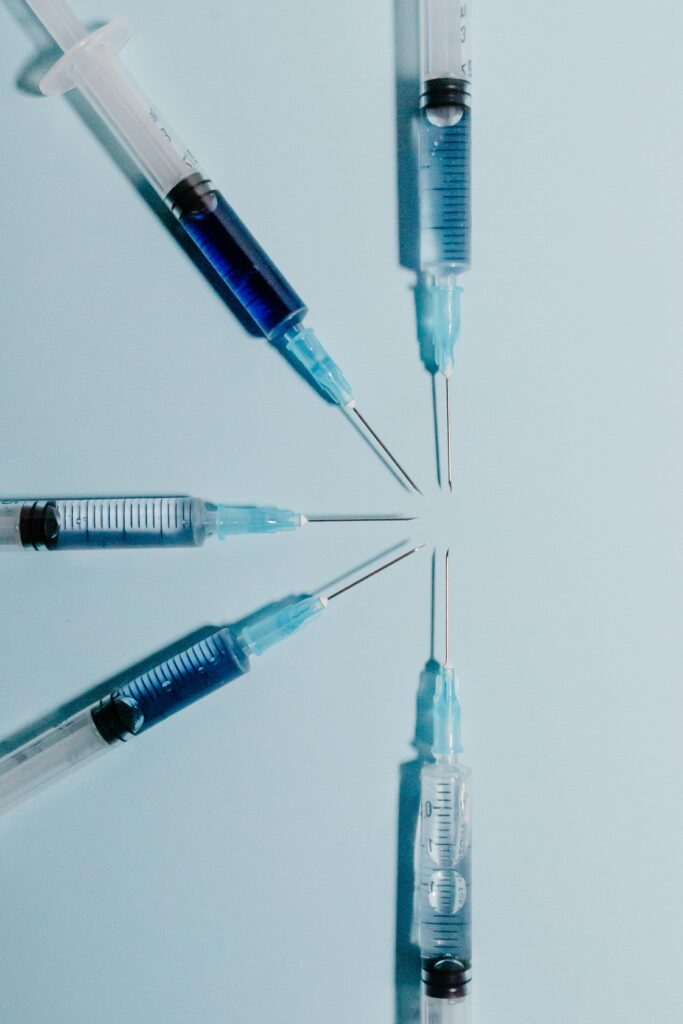 Multiple peptide injection syringes converging toward a center point, representing the targeted, customized peptide protocols designed at Good Chemistry in Cumming, GA.