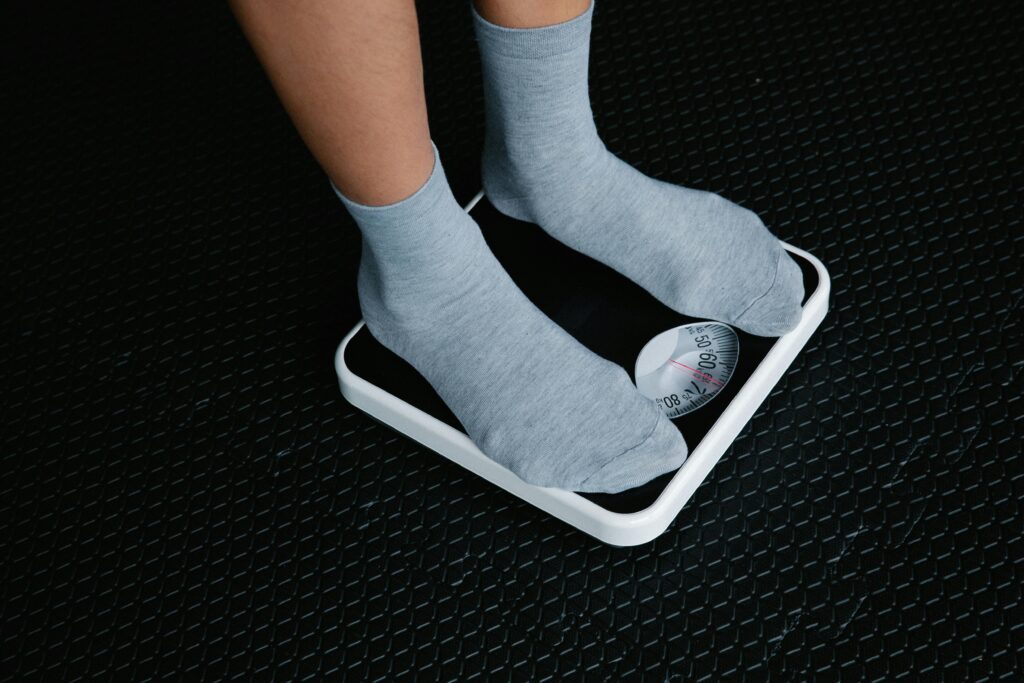 Person Standing on Scale Medical Weight Loss Cumming GA Good Chemistry