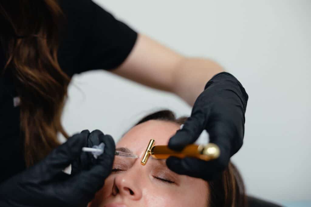 Close-up of a Xeomin neurotoxin injection near the brow line during a treatment session in Cumming, Georgia